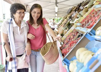 Senior woman going to grocery store with help of carer